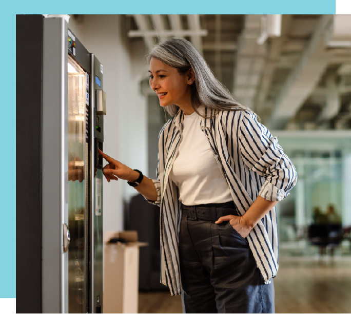 Woman ordering from a cashless vending machine