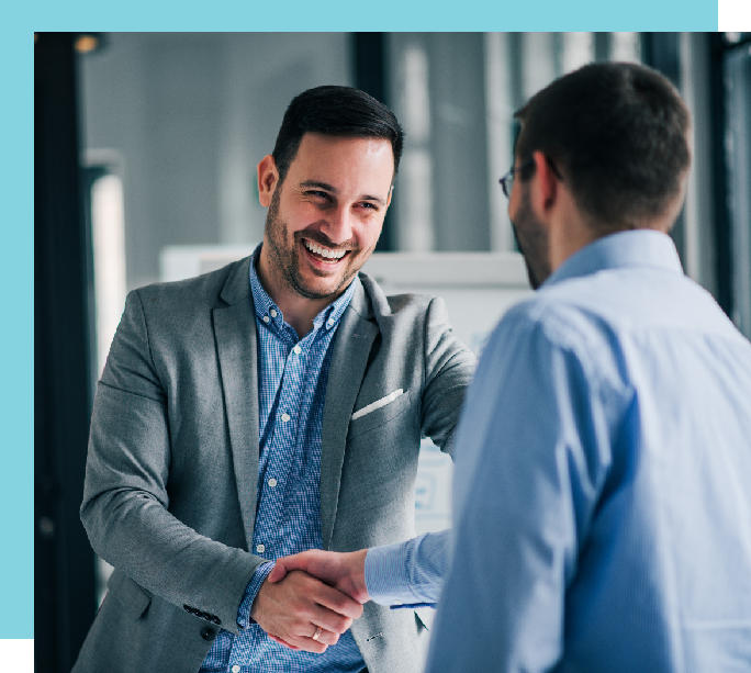 Two men smiling and shaking hands
