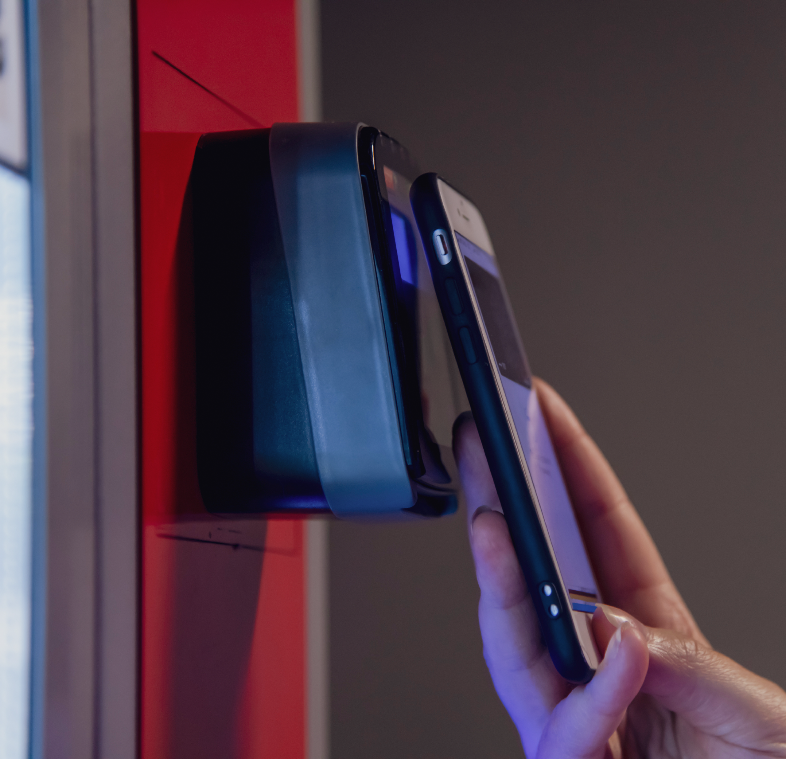 springhill-business-side Person paying on their phone at a cashless vending machine